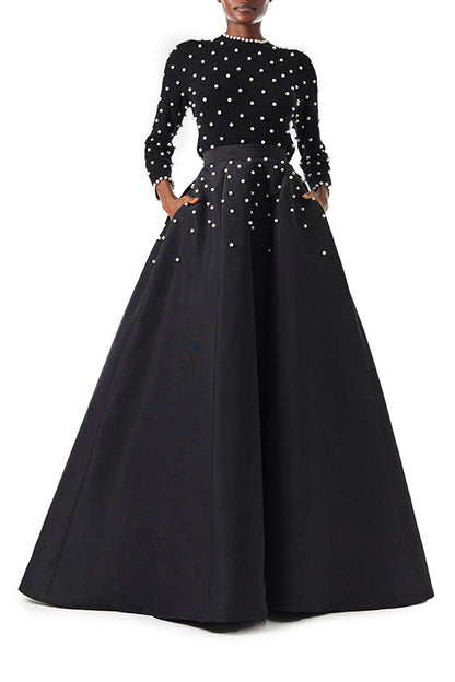 Monique Lhuillier Long sleeve Noir cashmere sweater with pearl embroidery and pearl trim at neckline and wrists - front with skirt.