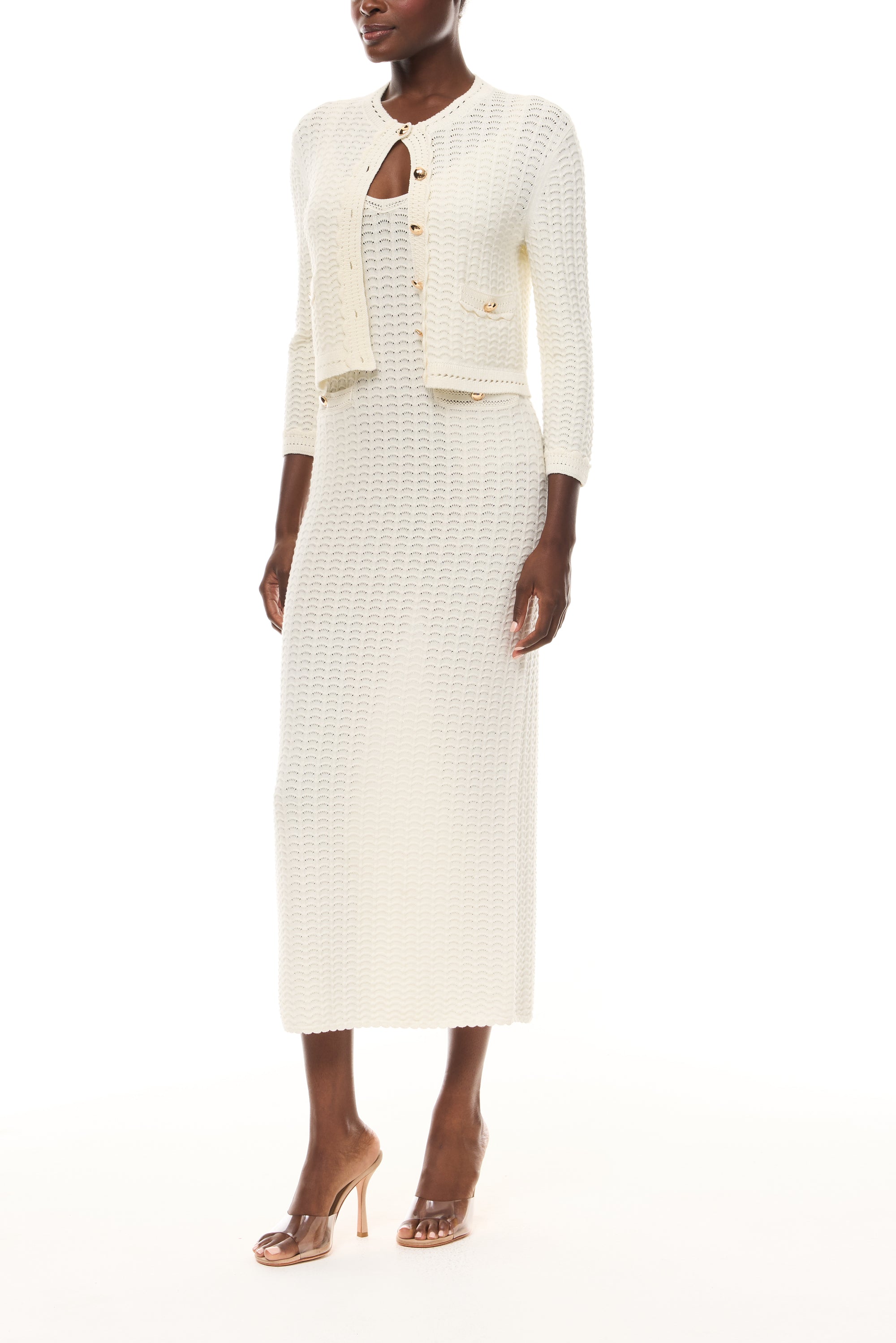 Monique Lhuillier Spring 2026 Ivory Cotton Viscose Knit Lace stitch cardigan with gold buttons with coordinating dress  - side.