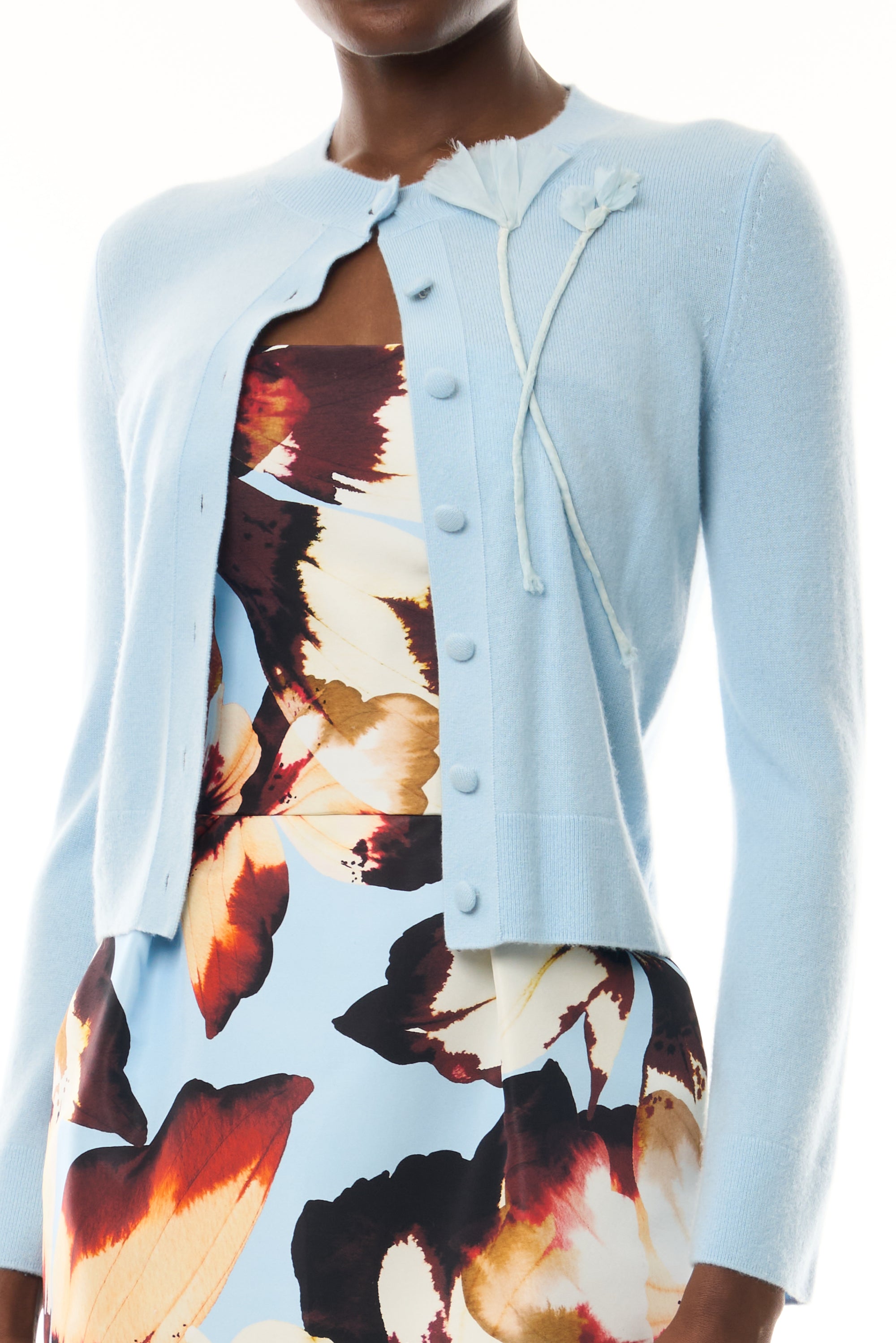 Monique Lhuillier Fall 2026 pale blue cashmere cardigan with floral applique - fabric.