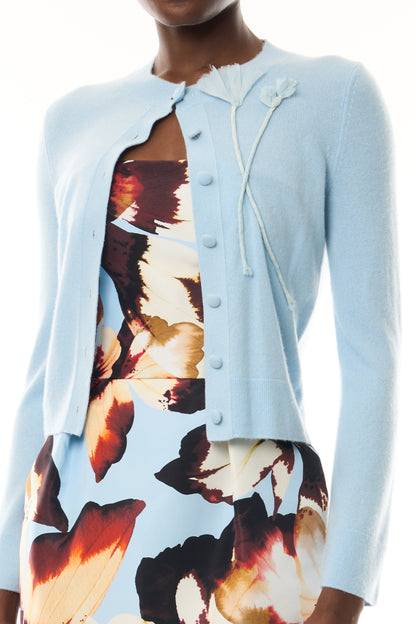 Monique Lhuillier Fall 2026 pale blue cashmere cardigan with floral applique - fabric.