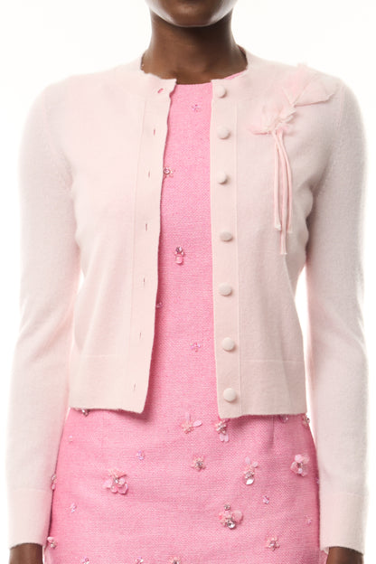 Monique Lhuillier Fall 2026 pale pink cashmere cardigan with floral applique - fabric. 