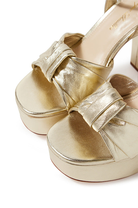Monique Lhuillier gold leather Kris platform heel with knotted toe strap and gold hardware.