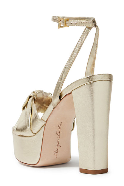 Monique Lhuillier gold leather Kris platform heel with knotted toe strap and gold hardware.