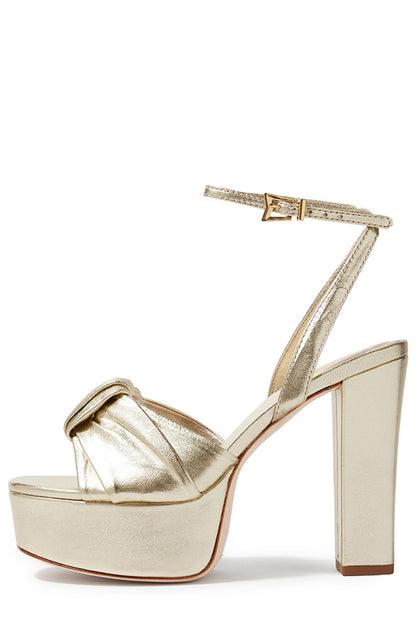 Monique Lhuillier gold leather Kris platform heel with knotted toe strap and gold hardware.