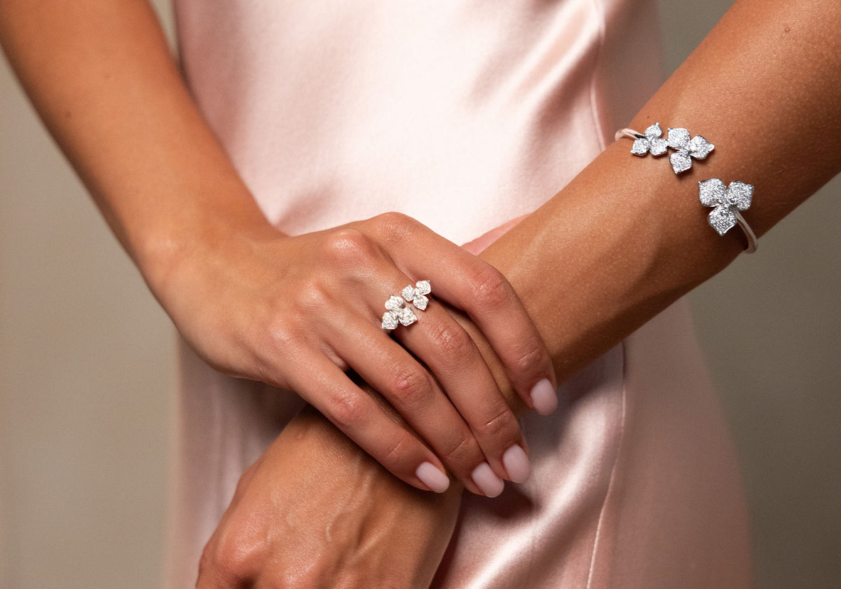 Monique Lhuillier Fall 2027 Bridal Ryder - V-neck slip dress in dusty rose crepe back satin and Chantilly lace featuring diamond floral ring and bracelet from Kay Jewelers collection. 