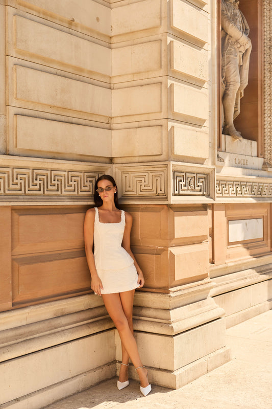 Monique Lhuillier Fall 2026 Silk White Clip Jacquard sleeveless peplum mini dress - lookbook. 
