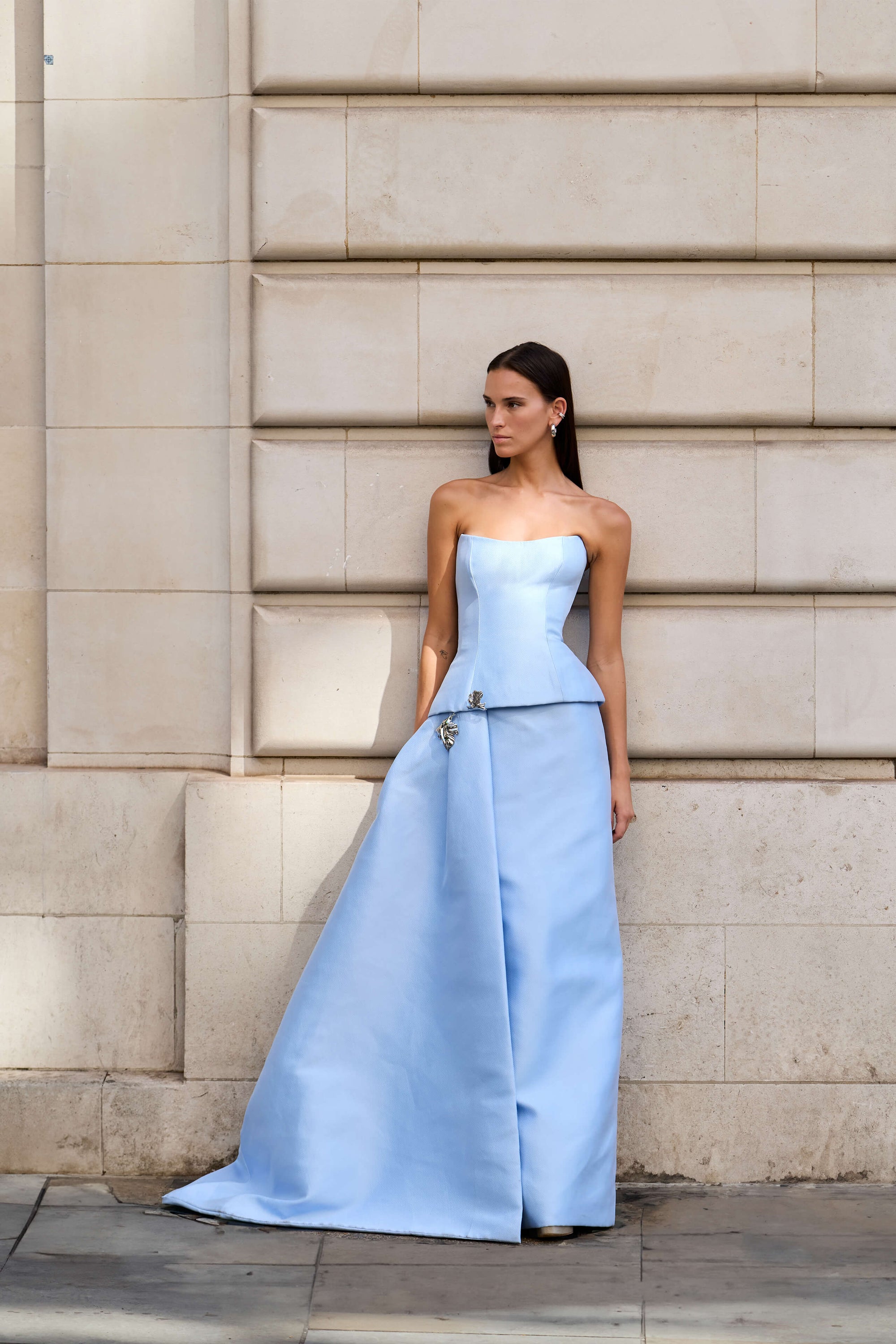 Monique Lhuillier Fall 2026 Breeze Mikado Piqué strapless peplum column gown with side train and silver floral embellishment - lookbook.