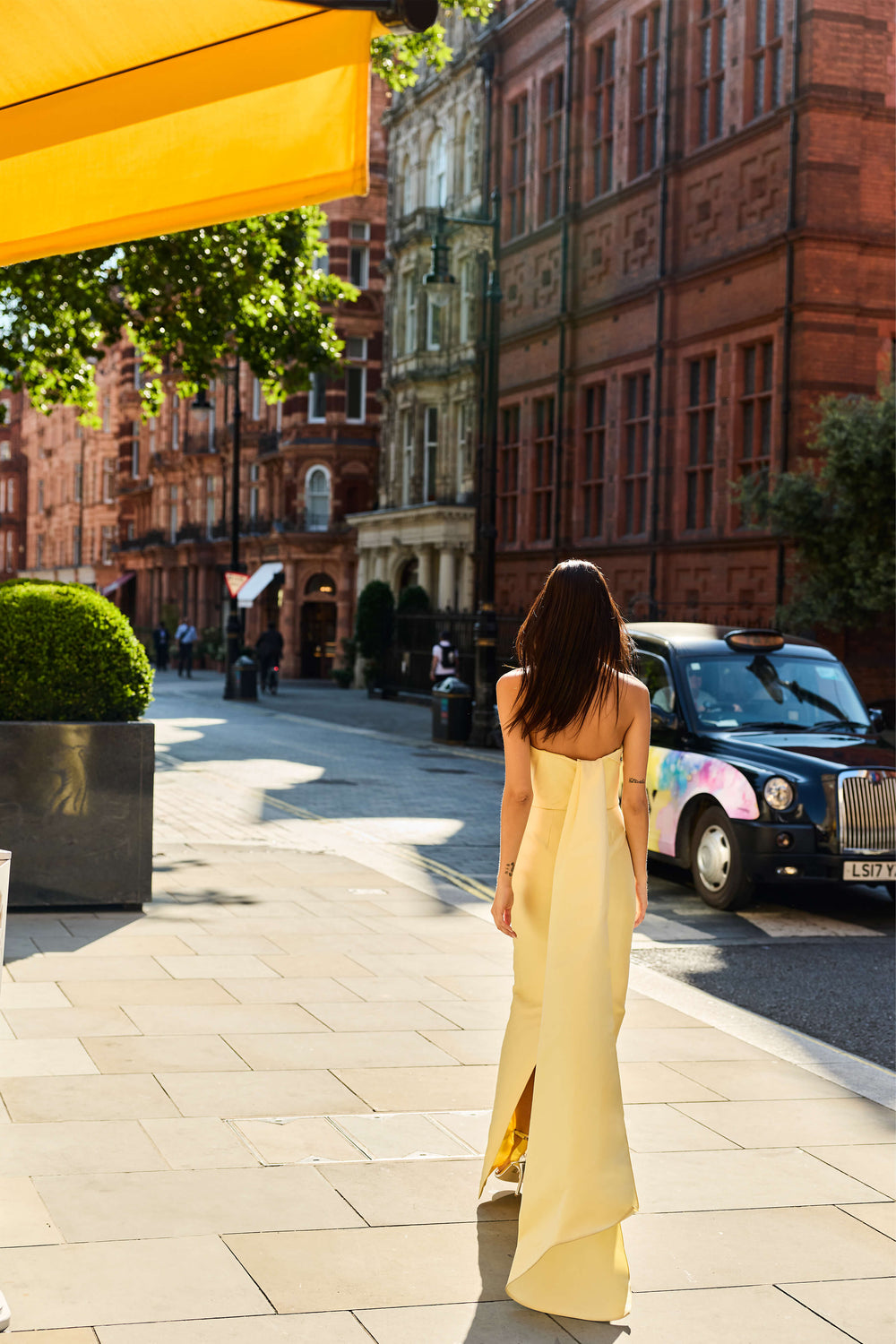 Monique Lhuillier Fall 2026 Pale Yellow Mikado Piqué strapless draped gown with train - lookbook.