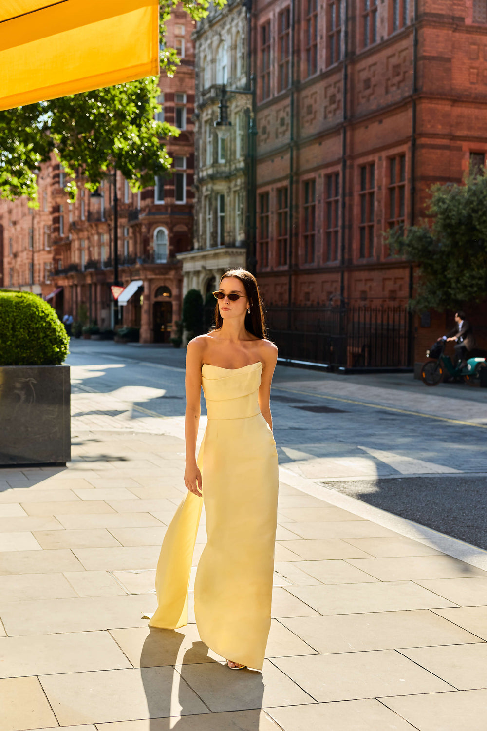 Monique Lhuillier Fall 2026 Pale Yellow Mikado Piqué strapless draped gown with train - lookbook.