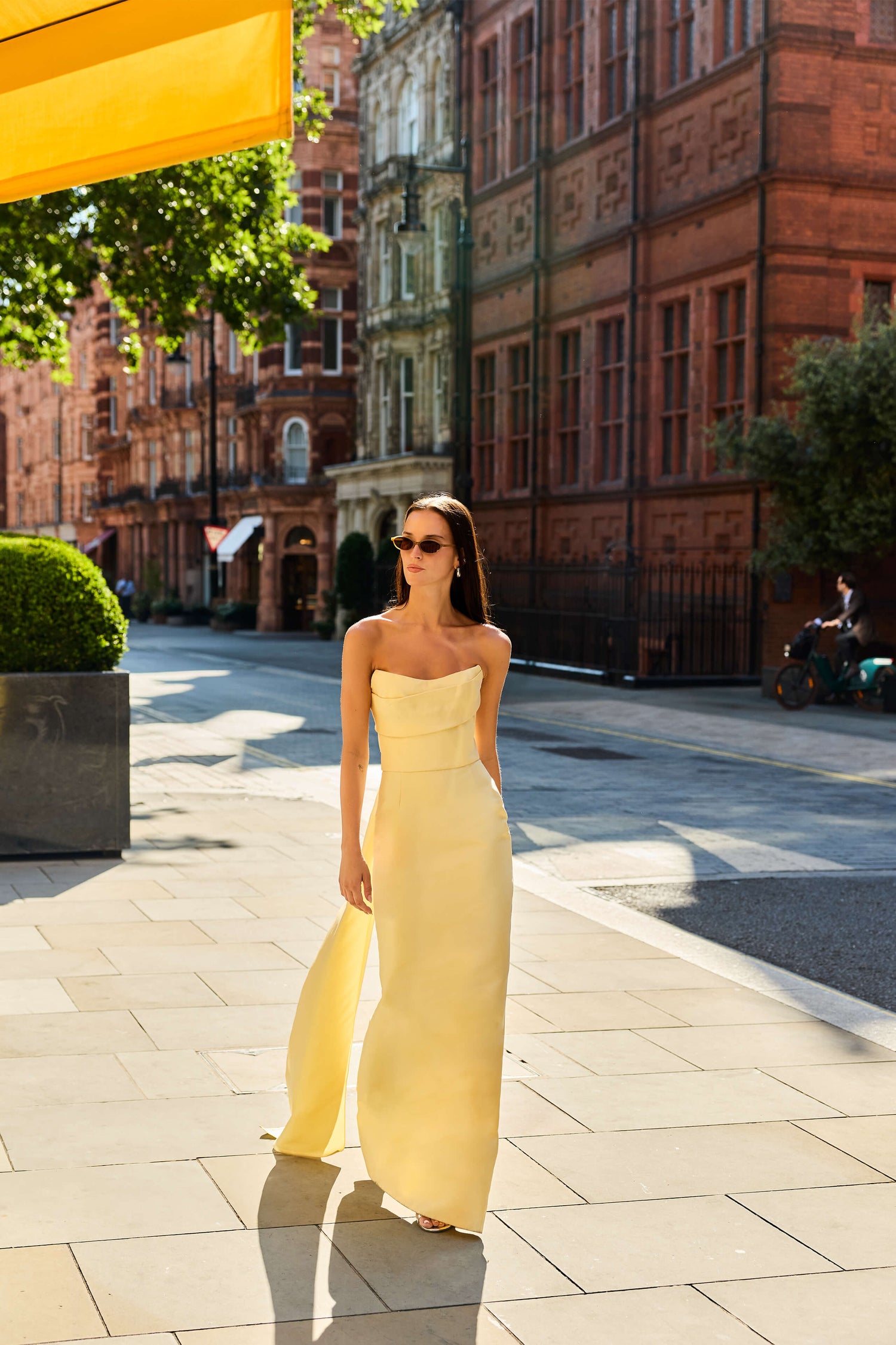 Monique Lhuillier Fall 2026 Pale Yellow Mikado Piqué strapless draped gown with train - lookbook.