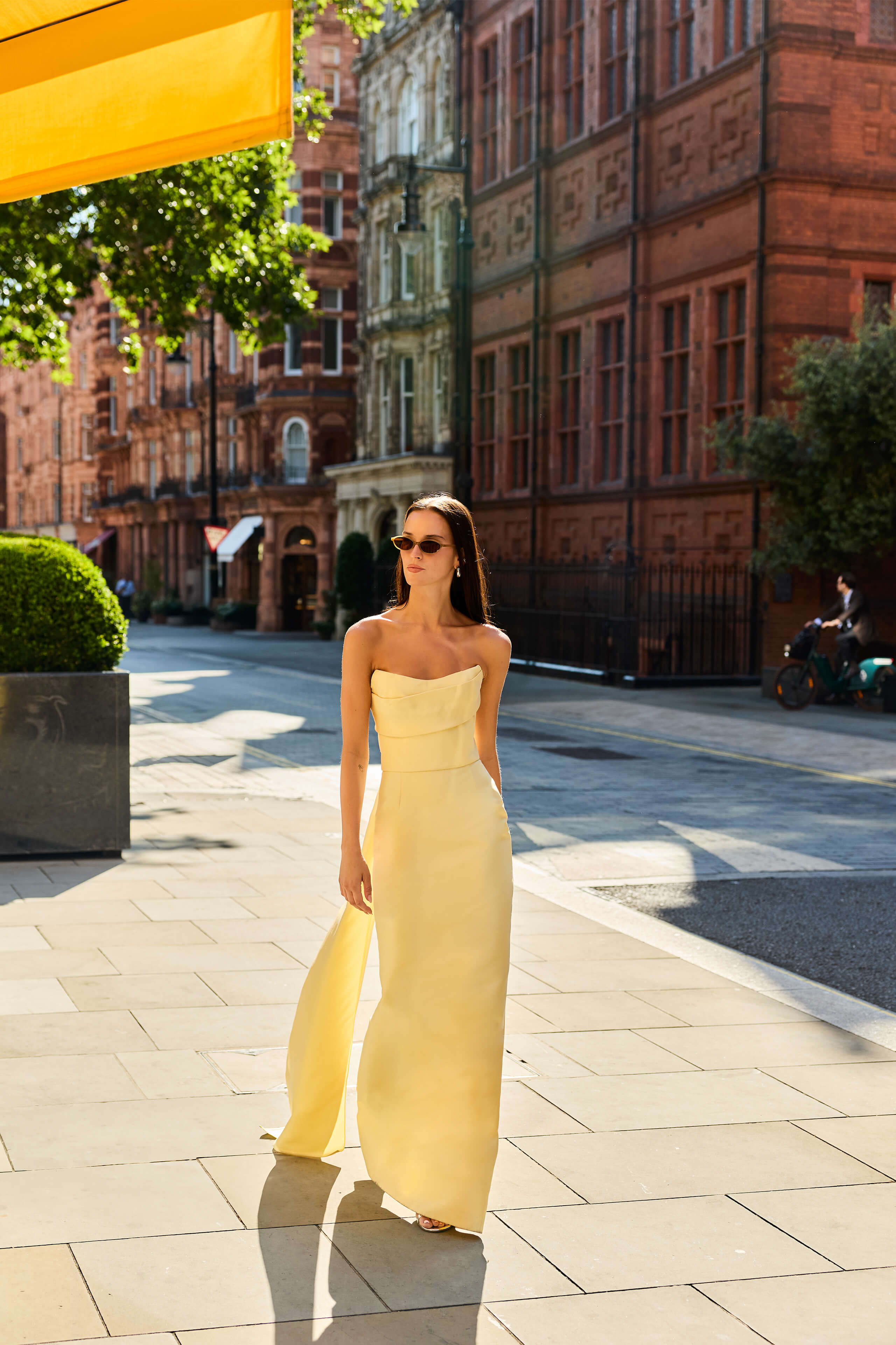 Monique Lhuillier Fall 2026 Pale Yellow Mikado Piqué strapless draped gown with train - lookbook.