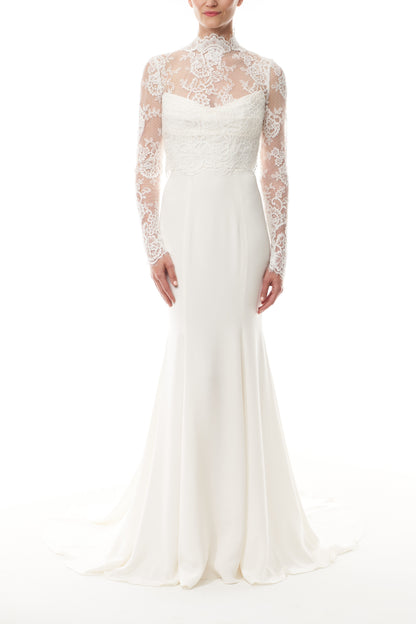 Silk white, long sleeve lace bridal jacket with high neck and hook eye closure at the back.  Shown over silk white satin gown - front.