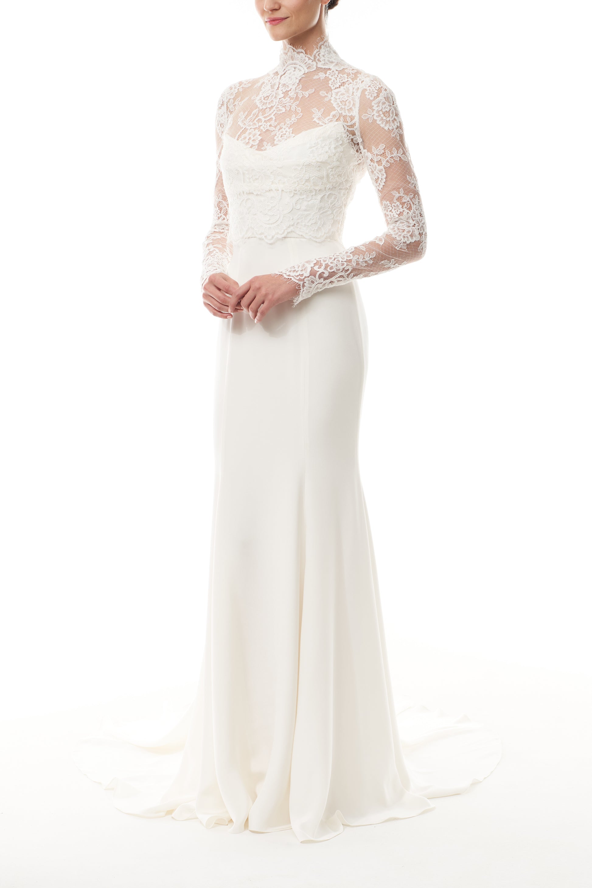 Silk white, long sleeve lace bridal jacket with high neck and hook eye closure at the back.  Shown over silk white satin gown - side.