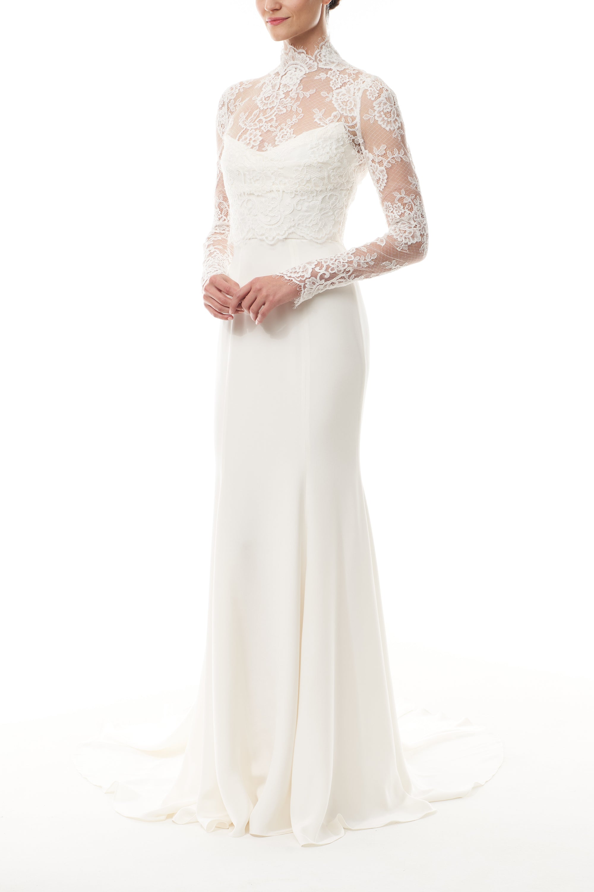 Silk white, long sleeve lace bridal jacket with high neck and hook eye closure at the back.  Shown over silk white satin gown - side.