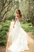 Woman walking in white embroidered off-the-shoulder modified a-line Monique Lhuillier Spring 2021 Celestina gown