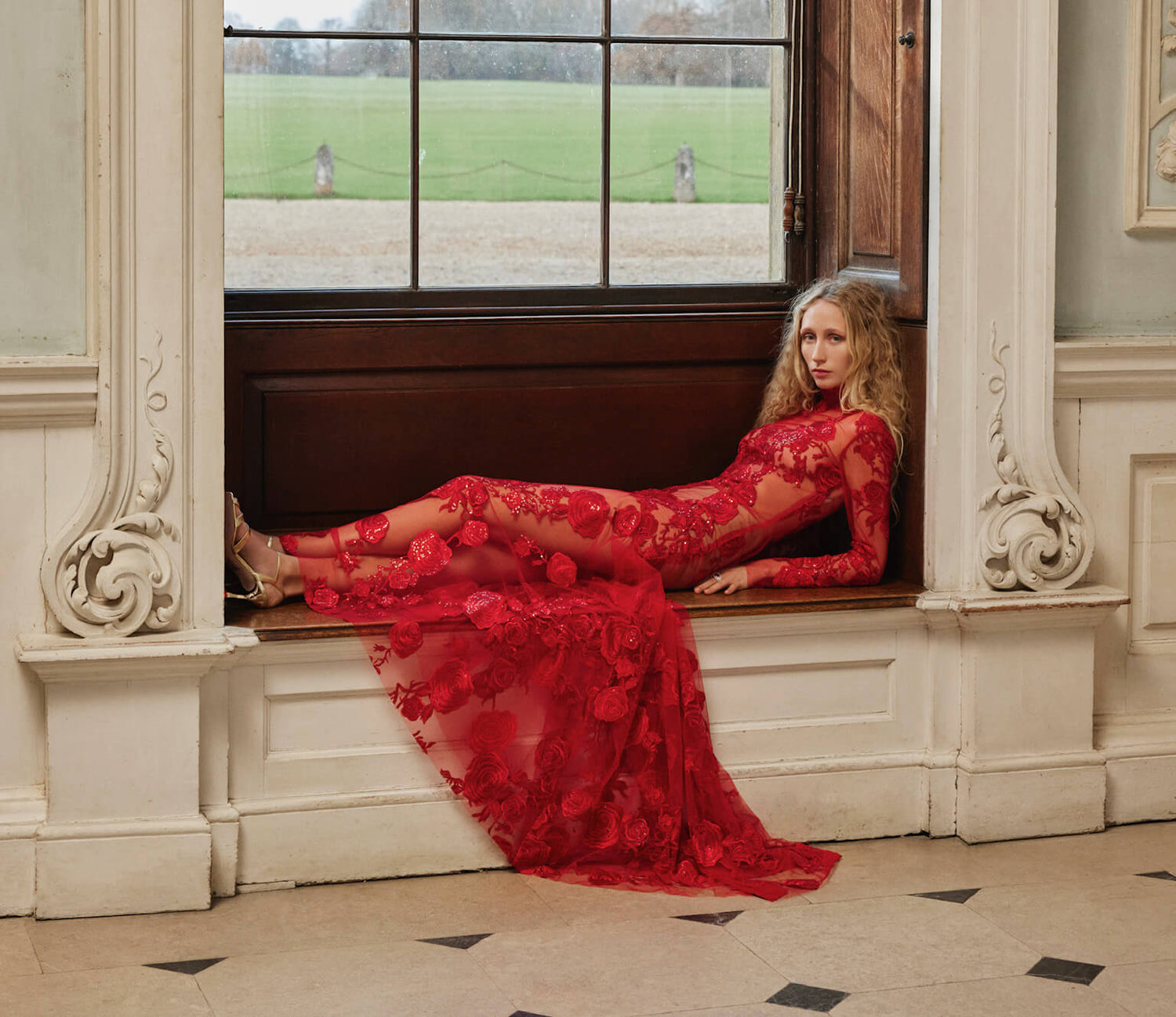 Red long sleeve embroidered tulle gown.