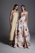 Monique Lhuillier Fall 2026: model on left wearing pale yellow embroidered strapless column gown; model on right wearing white/multi strapless floral printed ballgown with slit - lookbook.