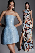 Monique Lhuillier Fall 2026 pale blue embroidered Mikado pique strapless structured mini dress; model on blue/floral Amber Lily printed faille one shoulder gown - lookbook.
