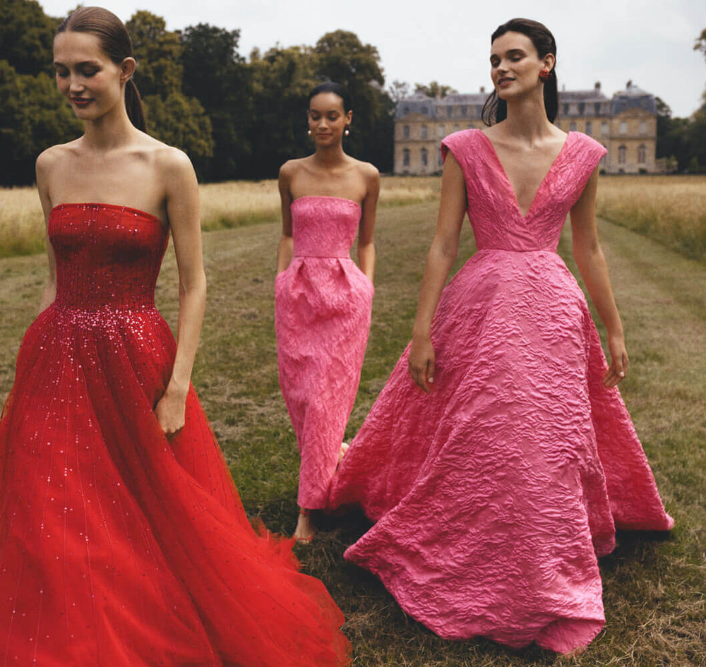 Monique Lhuillier Spring 2024 cherry red tulle gown, fuchsia jacquard ballgown and strapless dress.