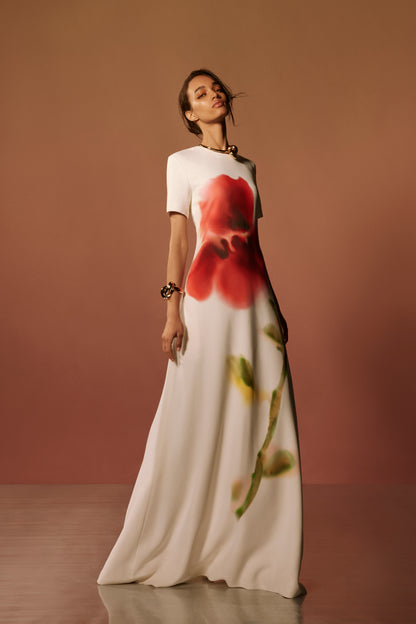 Monique Lhuillier Spring 2026 lookbook image - model wearing short sleeve Ivory/multi watercolor floral printed crepe a-line gown