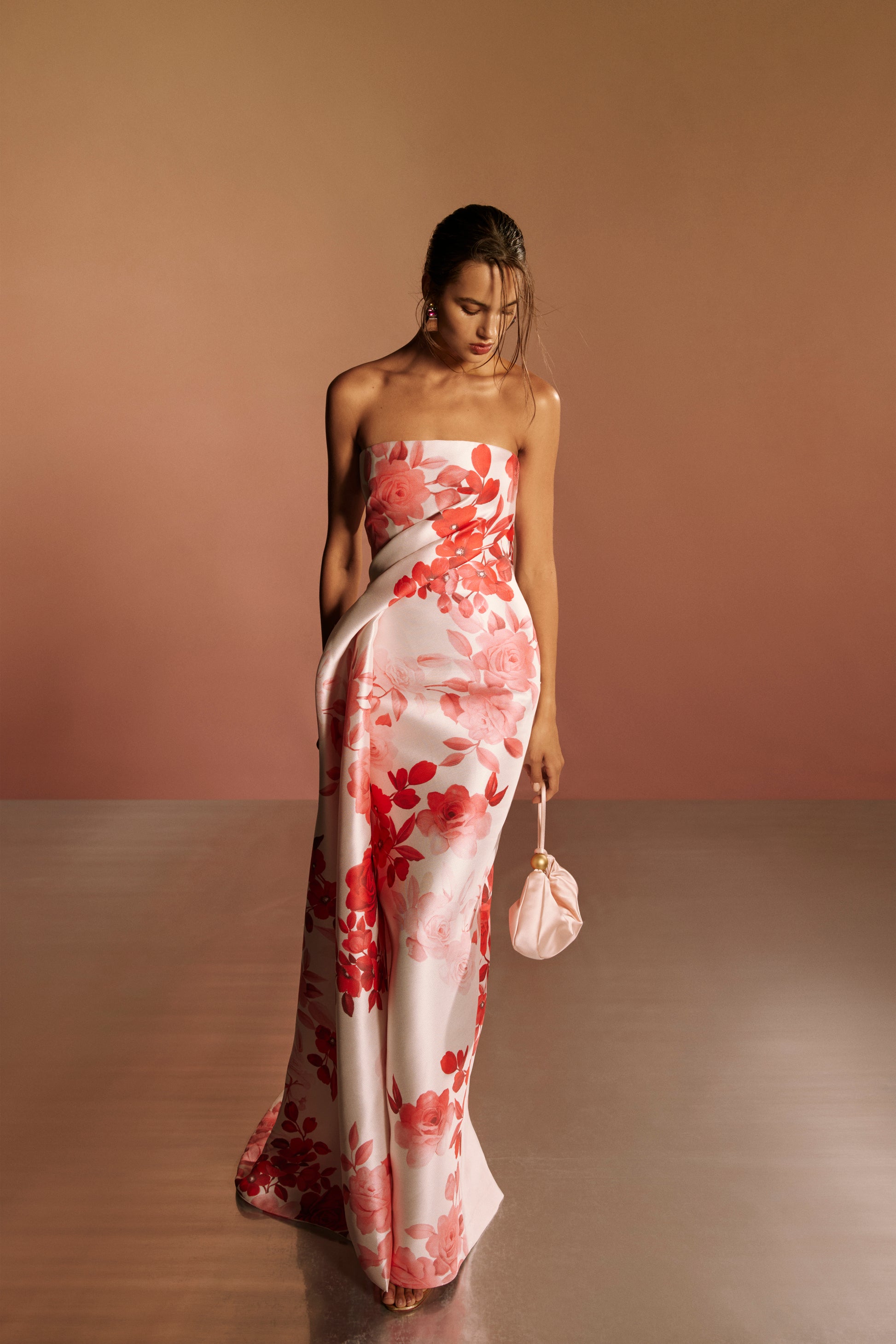 Monique Lhuillier Spring 2026 lookbook image - model wearing pink and white rose ombre printed satin strapless draped column gown 