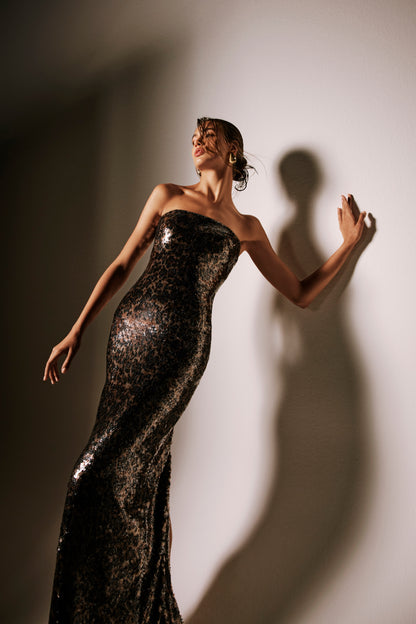 Monique Lhuillier Spring 2026 lookbook image - model wearing leopard sequin strapless column gown 