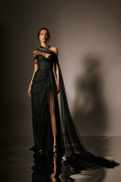 Monique Lhuillier Spring 2026 lookbook image - model wearing noir spanish tulle draped strapless gown with detachable wrap and streamers