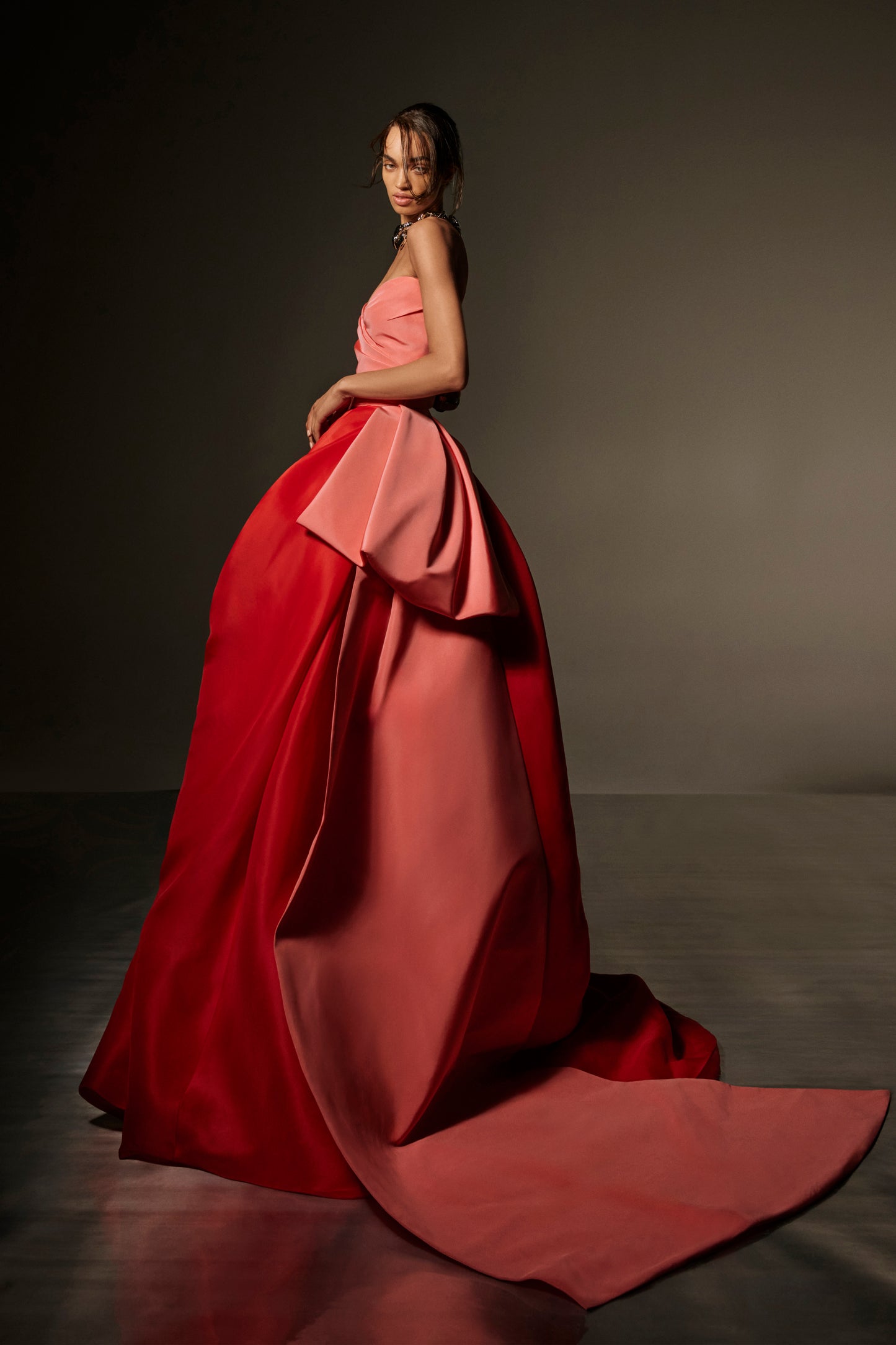 Monique Lhuillier Spring 2026 lookbook image- model wearing Plumeria/Poppy Faille/Gazar Strapless draped bodice gown with tufted skirt