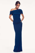 Monique Lhuillier Spring 2027 Sapphire Crepe Jersey asymmetric draped gown with gold metal piercing at hip - lookbook.