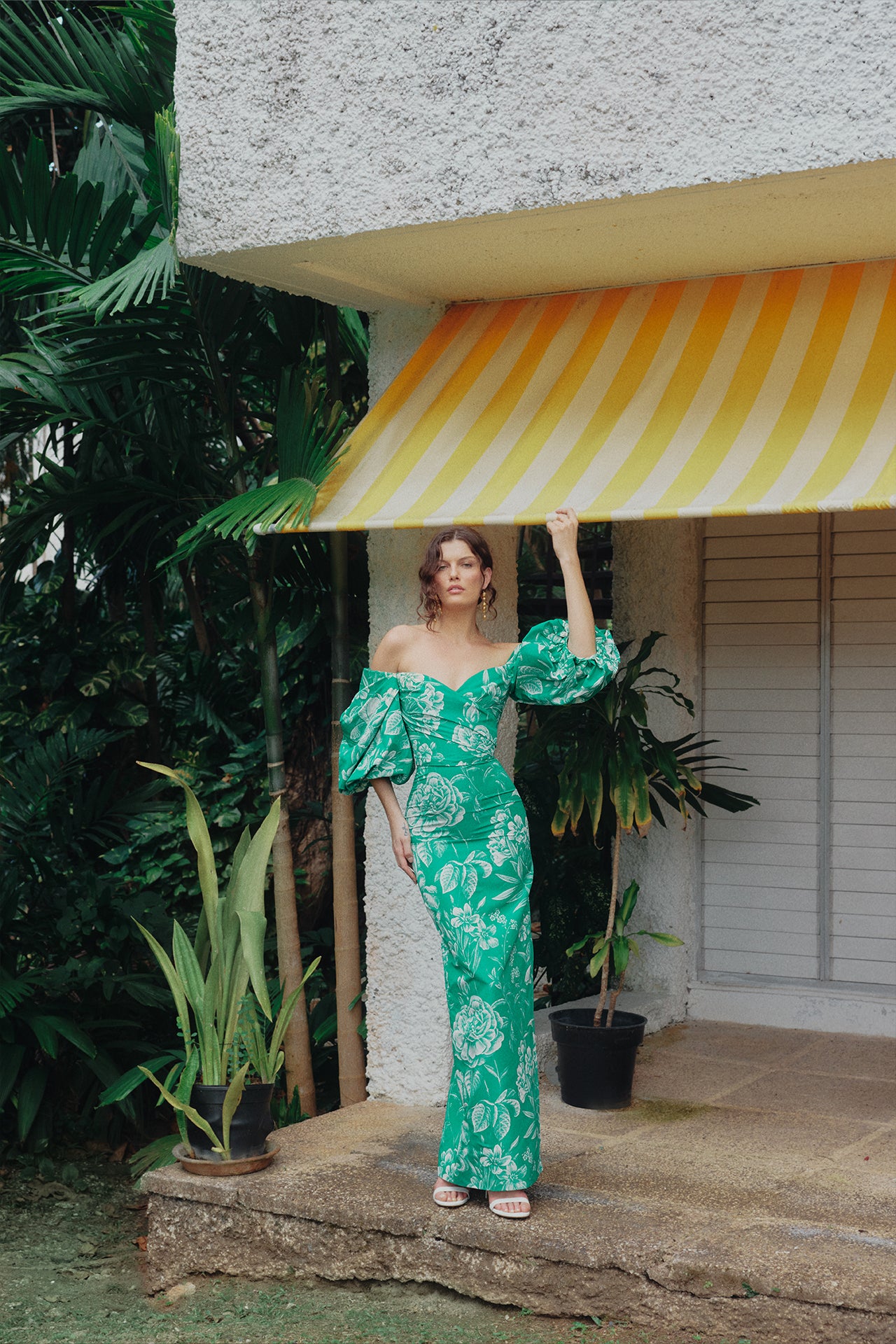 Monique Lhuillier Spring 2025 Off-the-shoulder column gown with blouson sleeves in Grass and Silk White Floral toile printed faille - lookbook photo on model.  