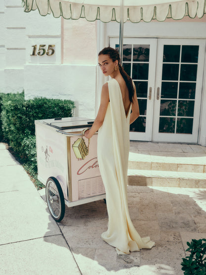 Monique Lhuillier Spring 2025 draped shoulder caftan gown with integral cape and side slit in limoncello yellow - lookbook.