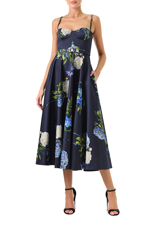 Monique Lhuillier Fall 2024 blue floral spaghetti strap, a-line midi dress with corseted bodice, pockets and belted waist - front.