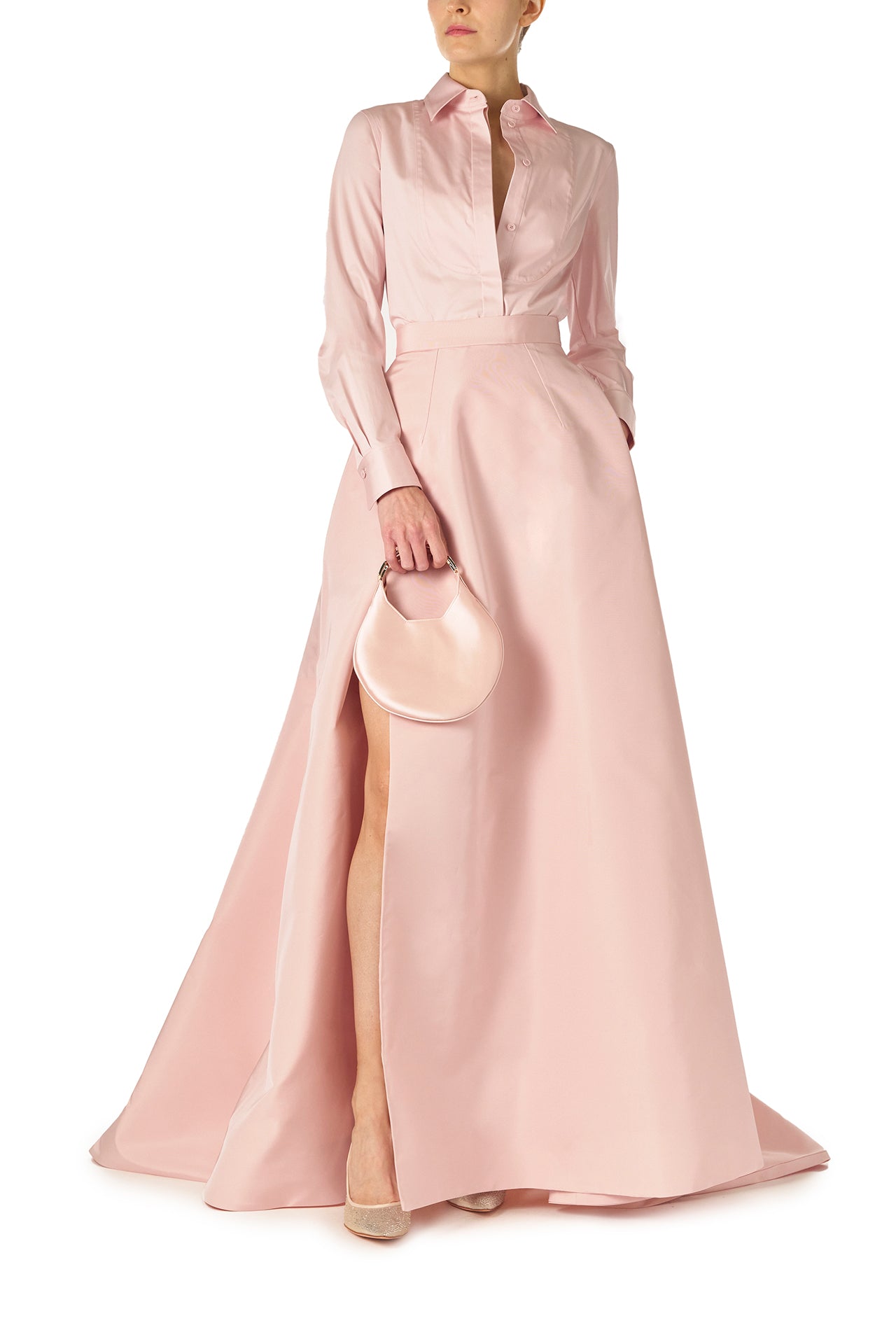 Monique Lhuillier Fall 2024 Full ball skirt with high leg slit and pockets in Pale Blush faille fabric - front with Demi bag.