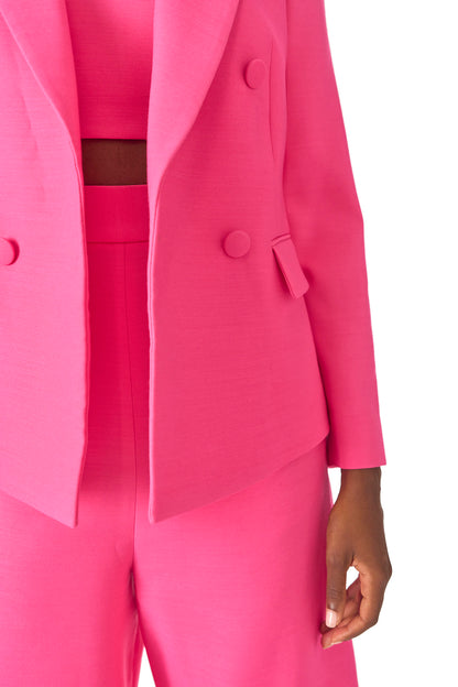 Monique Lhuillier Spring 2025 double-breasted tuxedo jacket in hibiscus wool-silk suiting - detail.