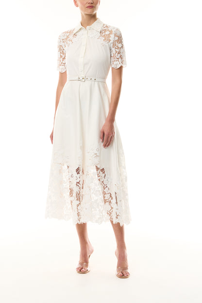 Monique Lhuillier Spring 2025 white cotton poplin dress with lace applique inserts, short sleeves, button down front bodice and belted waist - front.