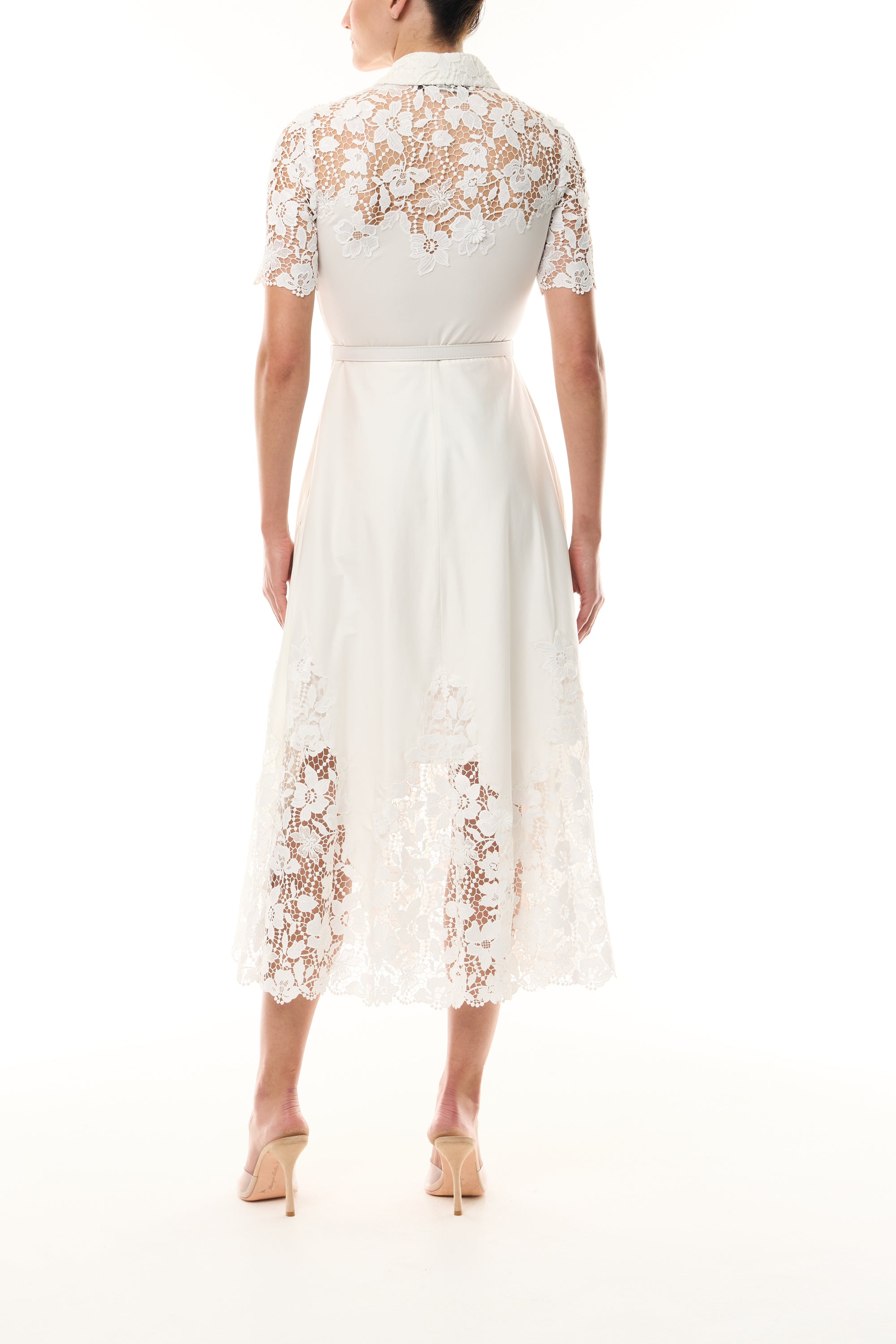 Monique Lhuillier Spring 2025 white cotton poplin dress with lace applique inserts, short sleeves, button down front bodice and belted waist - back.