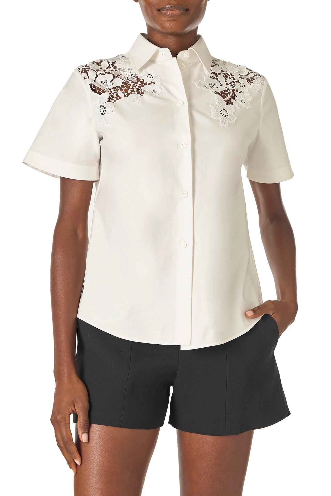 Monique Lhuillier Spring 2025 Short sleeve, button-down shirt with collar in white cotton poplin and lace applique details at shoulder - front.