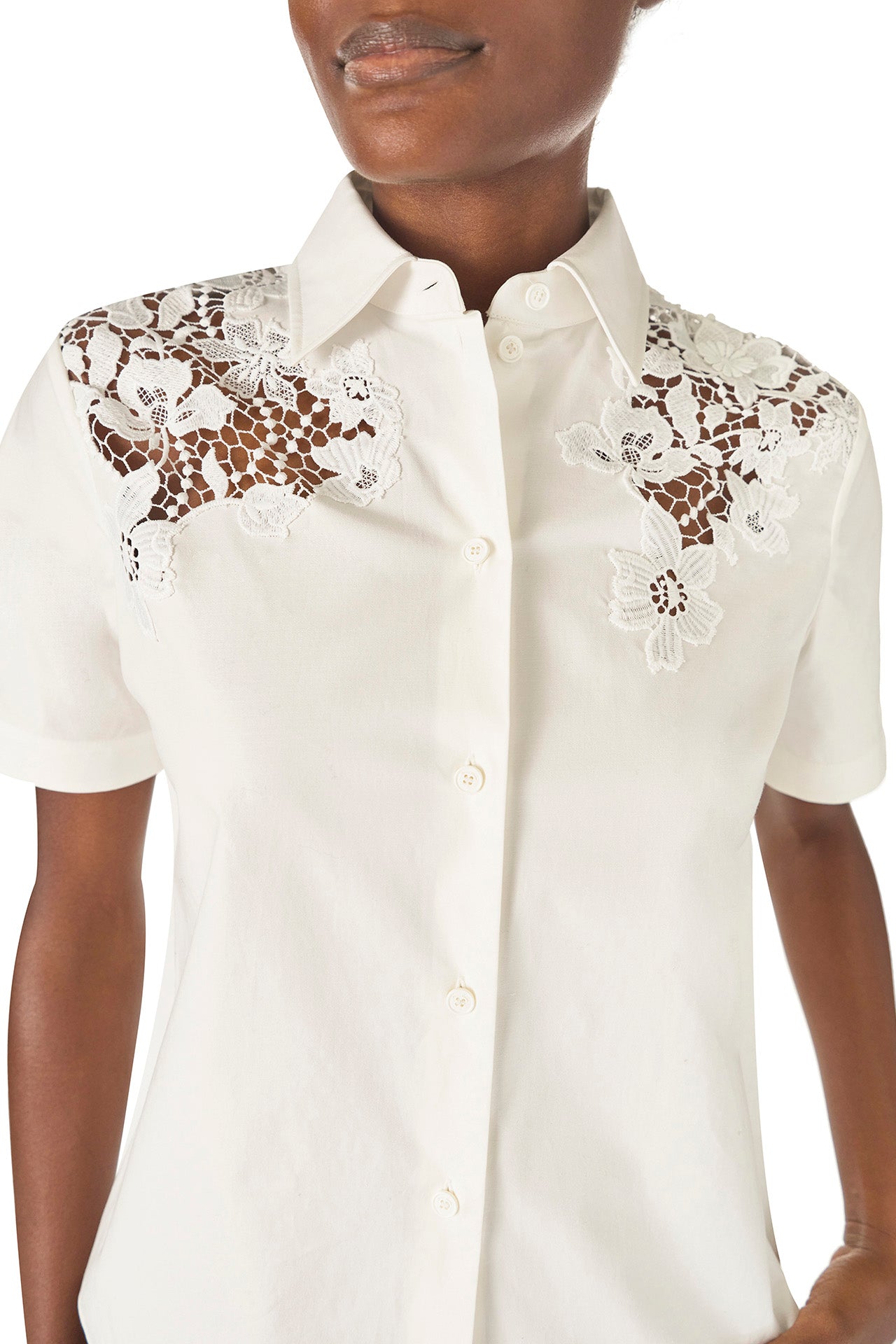 Monique Lhuillier Spring 2025 Short sleeve, button-down shirt with collar in white cotton poplin and lace applique details at shoulder - lace detail.