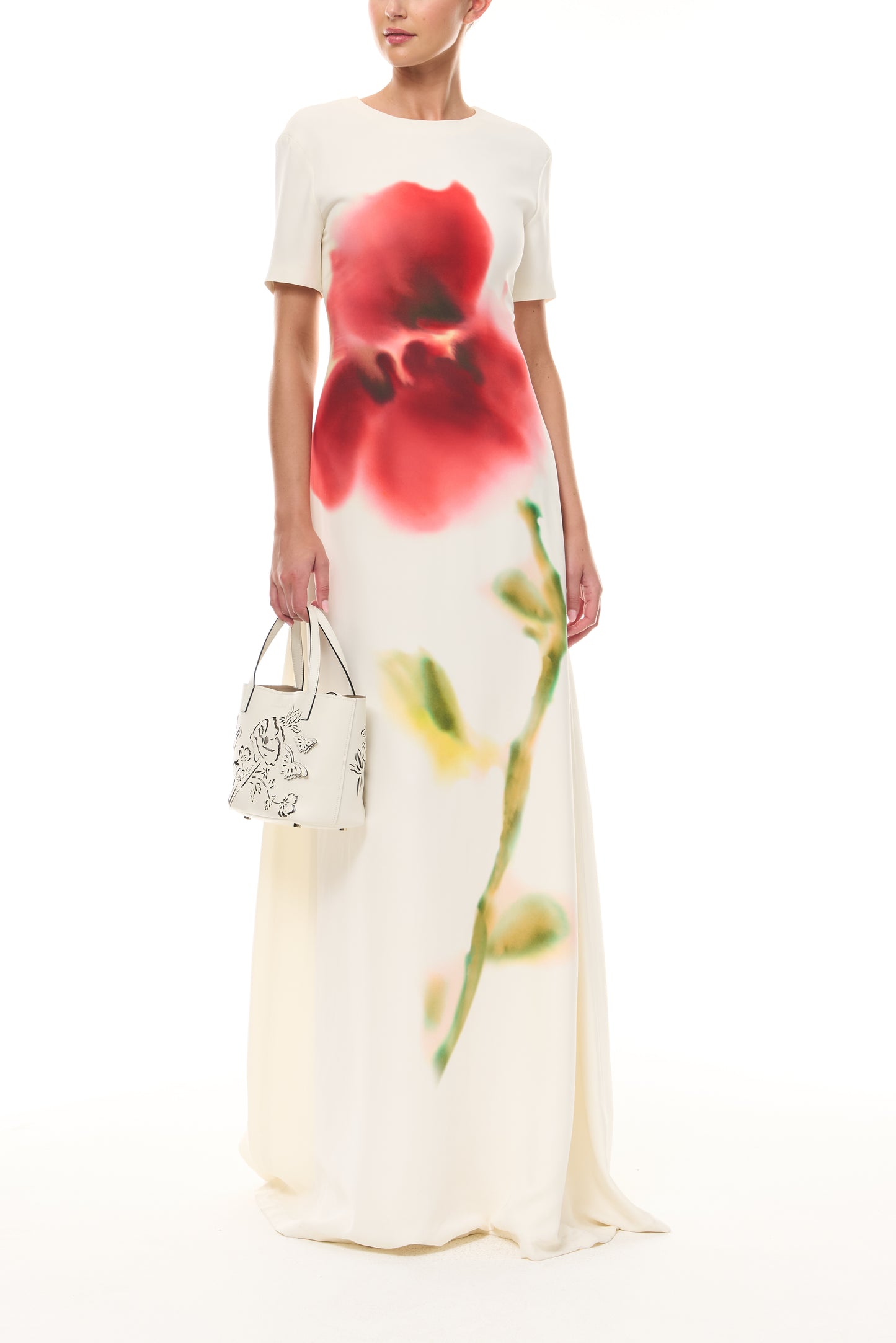 Monique Lhuillier Spring 2026 Ivory/Multi Watercolor Floral Printed Crepe Short -sleeve A-line gown - front with Ivory Colette Mini Tote Bag