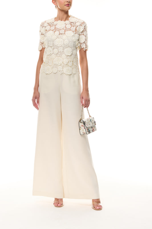 Monique Lhuillier Spring 2026 Ivory three dimensional floral lace Short sleeve blouse
with separate camisole - front with Rhea Mini Tuileries Shoulder Bag