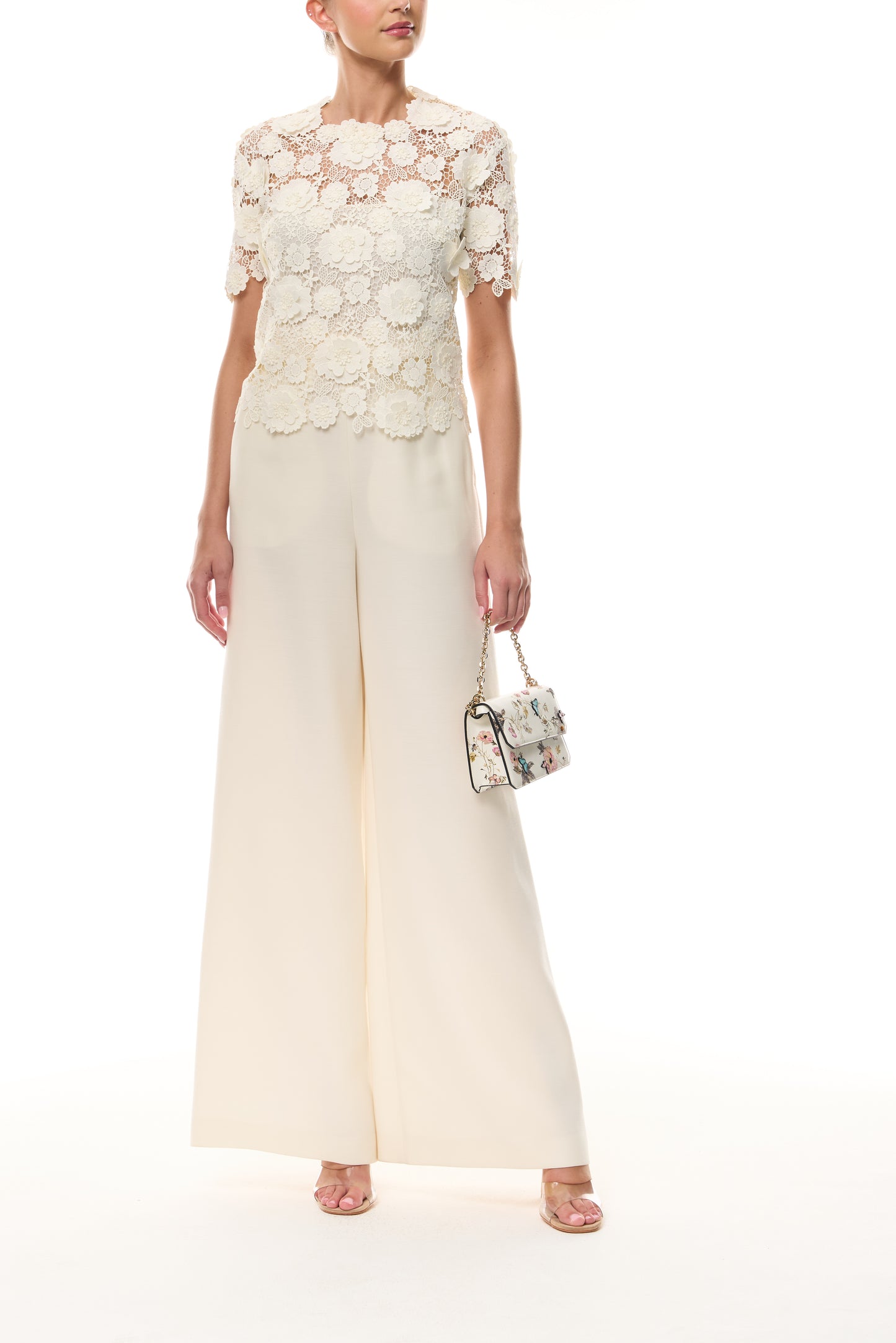 Monique Lhuillier Spring 2026 Ivory three dimensional floral lace Short sleeve blouse
with separate camisole - front with Rhea Mini Tuileries Shoulder Bag