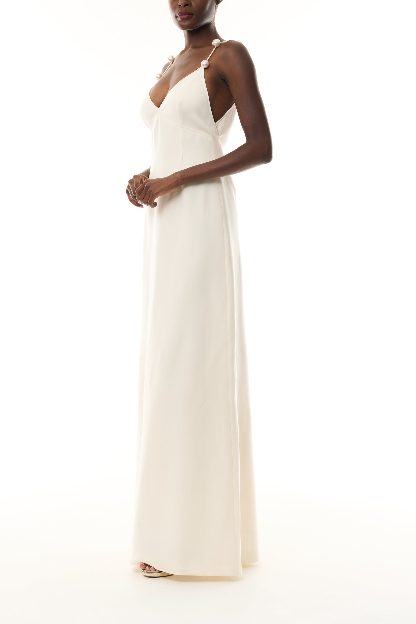Monique Lhuillier Spring 2026 Ivory Lightweight Silk Wool Suiting A - line V -neck gown with pearl ball straps - side.
