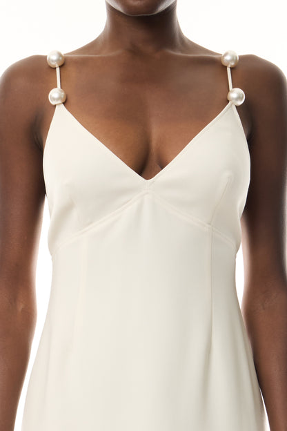 Monique Lhuillier Spring 2026 Ivory Lightweight Silk Wool Suiting A - line V -neck gown with pearl ball straps - fabric.