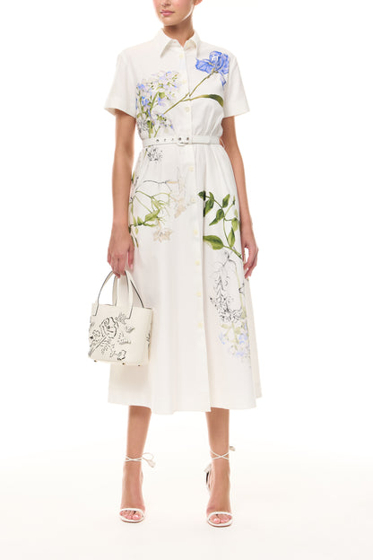 Monique Lhuillier Spring 2026 Silk White Multi Iris Bouquet Printed Cotton Poplin short-sleeved shirt dress with belt - front with Ivory Colette Mini Tote Bag.