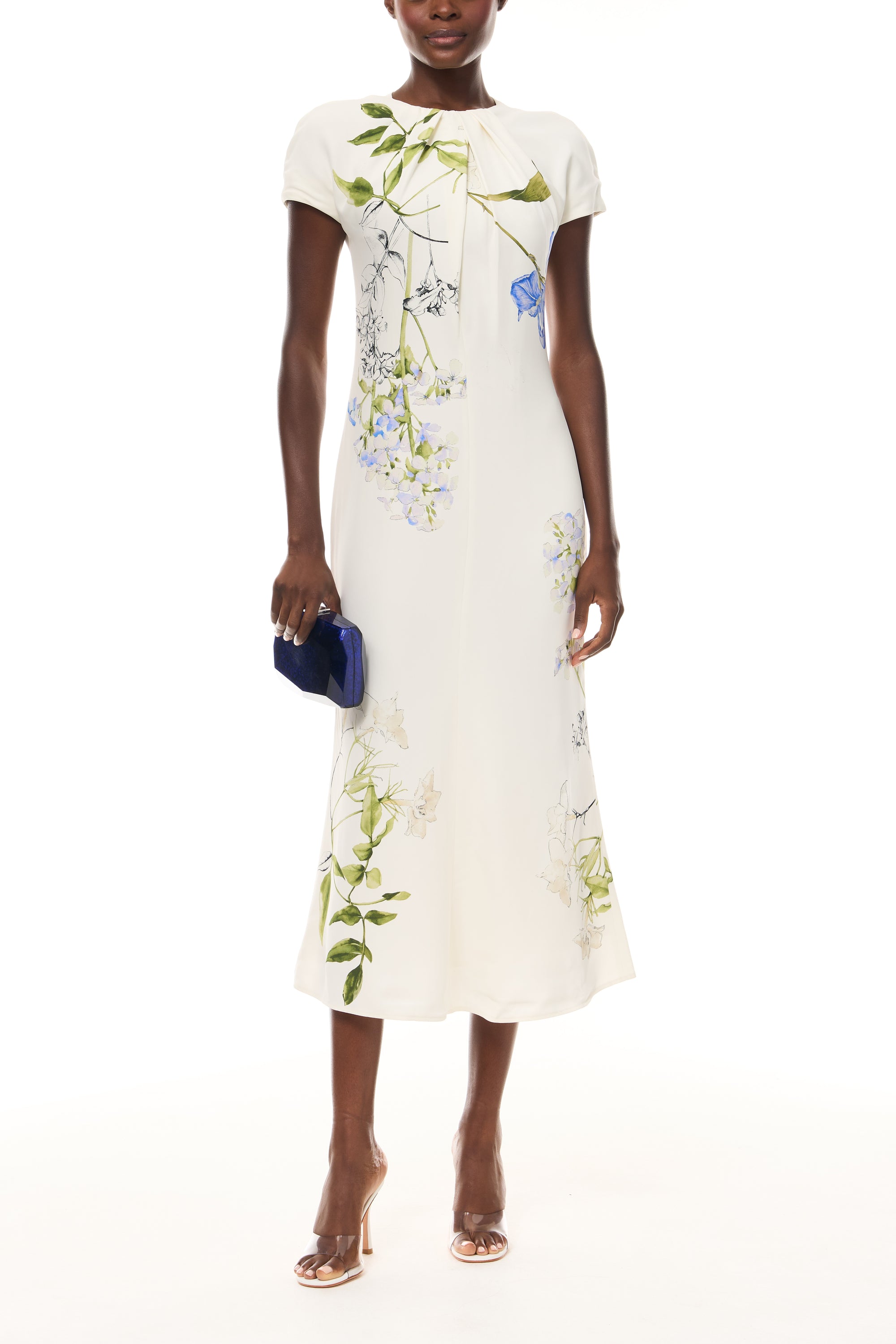 Monique Lhuillier Spring 2026 Ivory/Multi Iris Bouquet Printed Crepe Draped neckline cap sleeve dress - front with Blue Dasha Minaudière