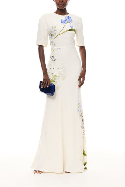 Monique Lhuillier Spring 2026 Ivory/Multi Iris Bouquet Printed CrepeShort sleeve bias gown - front with Blue Dasha Minaudière