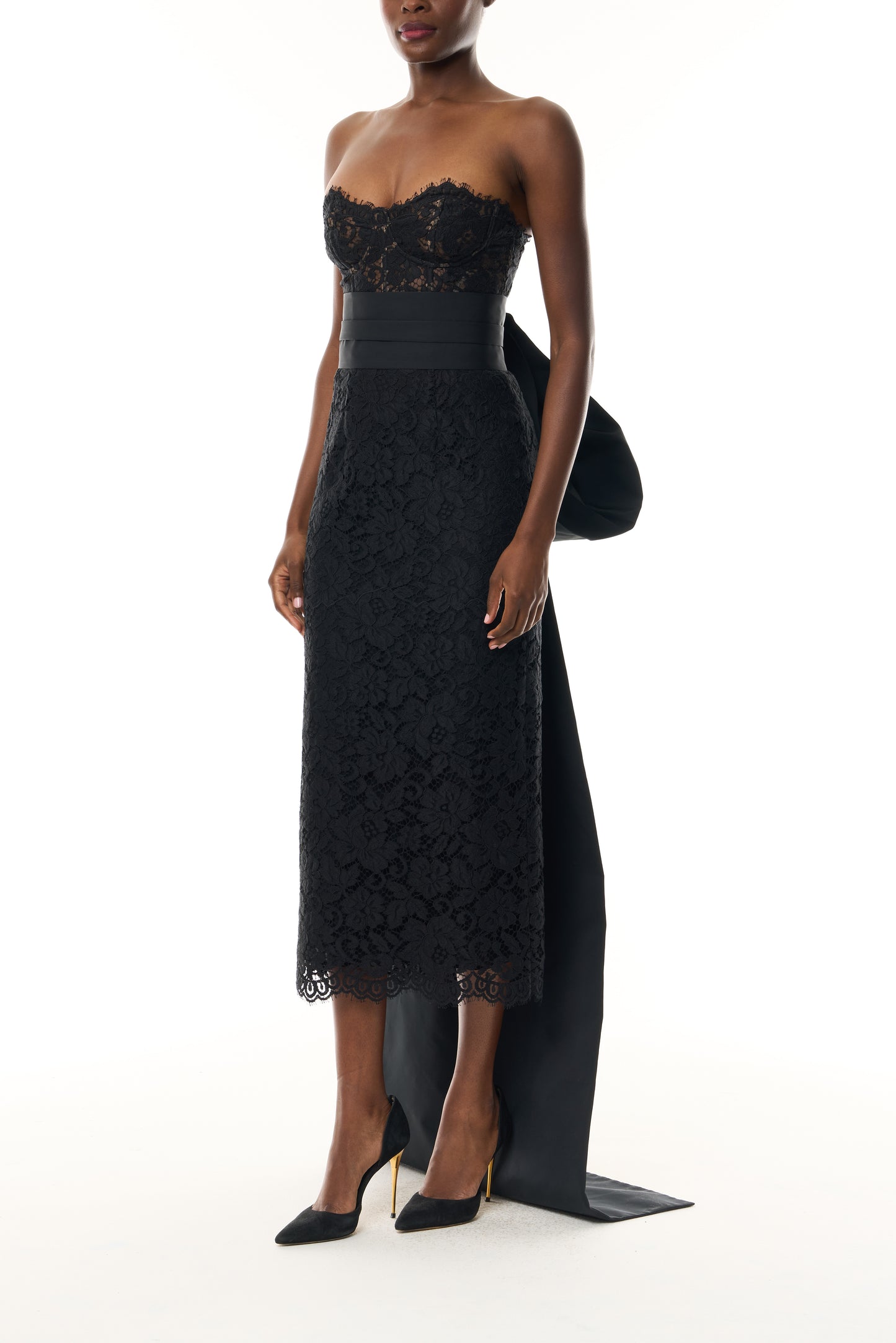 Monique Lhuillier Fall 2026 Strapless Midi Cocktail Dress in Noir Peony lace with Noir Silk Faille sash and train - side.
