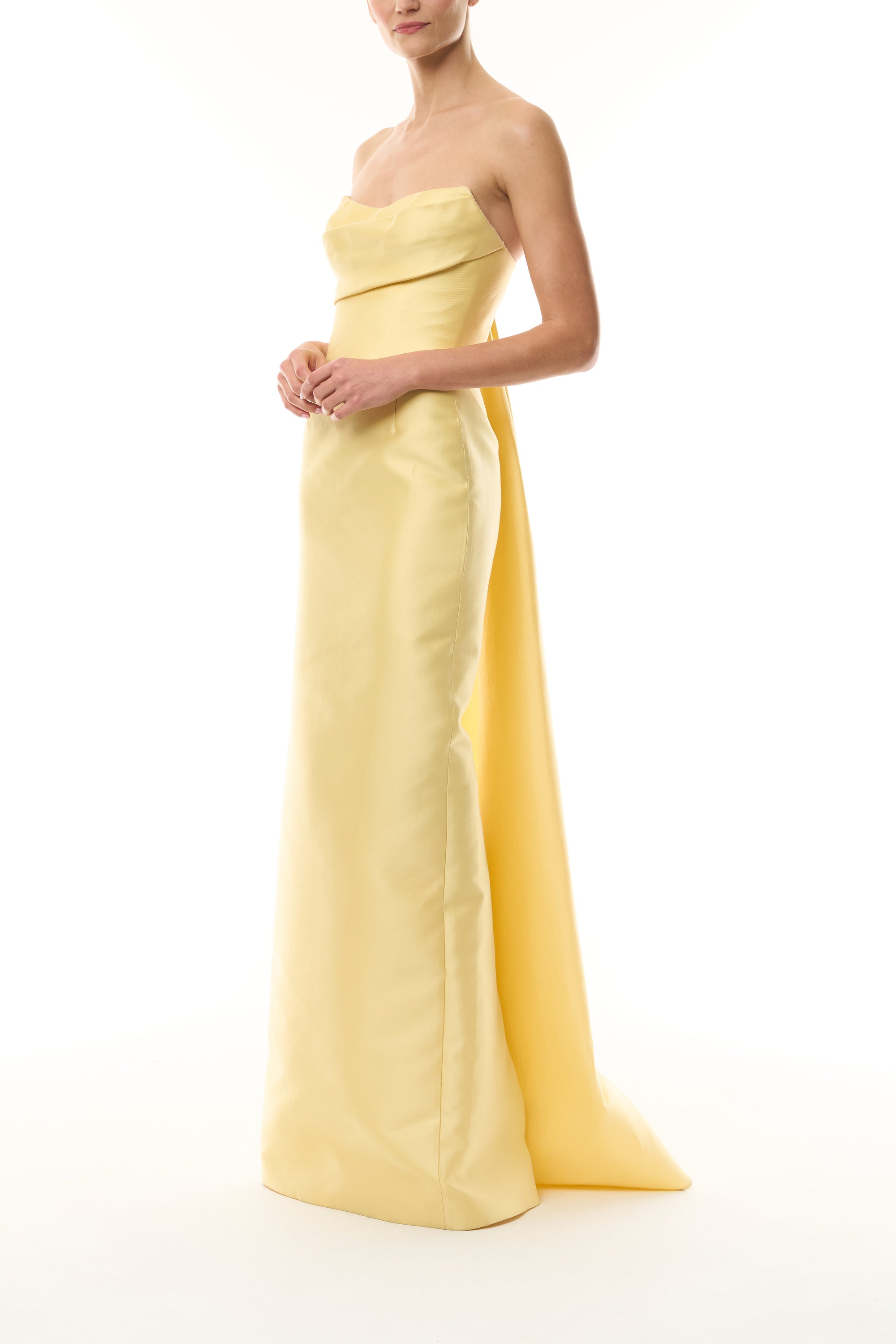 Monique Lhuillier Fall 2026 Pale yellow Mikado Piqué strapless column gown with train - side.