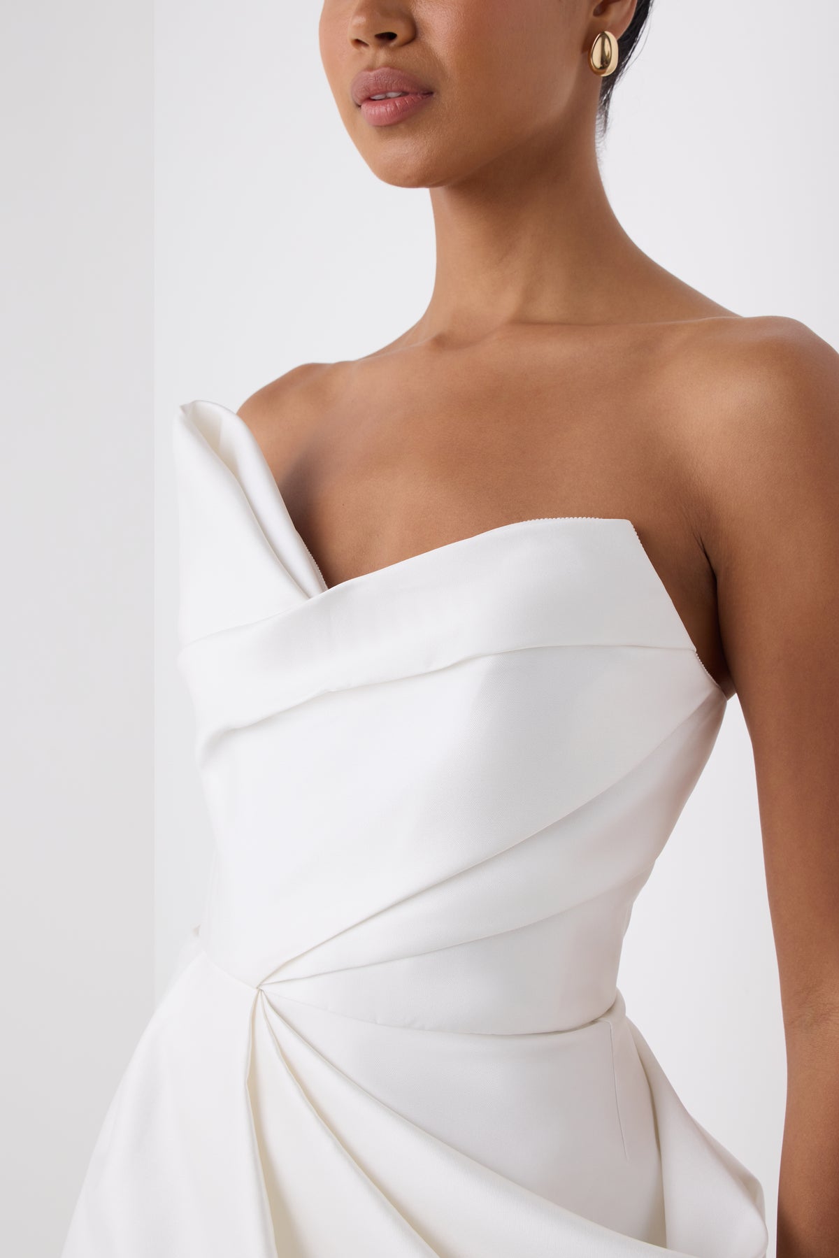 Monique Lhuillier Fall 2026 Strapless Mini Cocktail Dress in Silk White Mikado with draped skirt and asymmetrical neckline - fabric.