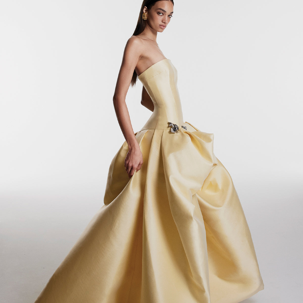 Monique Lhuillier Fall 2026 Pale Yellow Mikado Pique strapless ballgown with train and floral embellishment - lookbook.